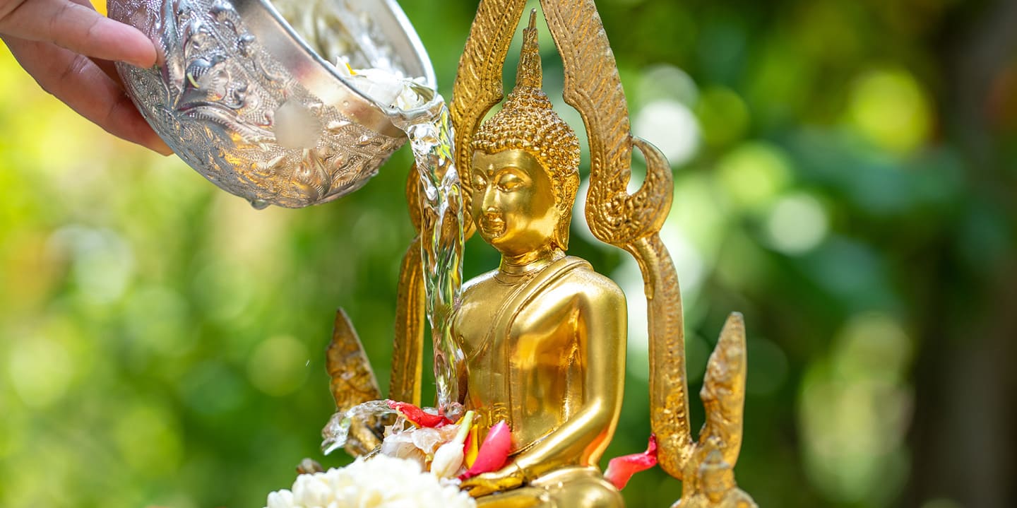 Songkran ritual of pouring water on buddha